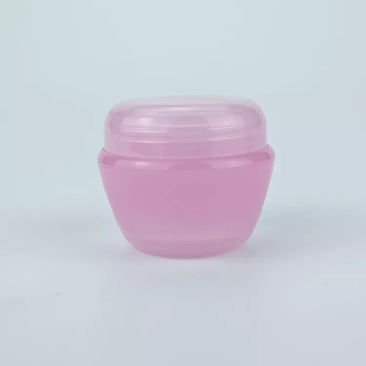Pink plastic cosmetic cream jar